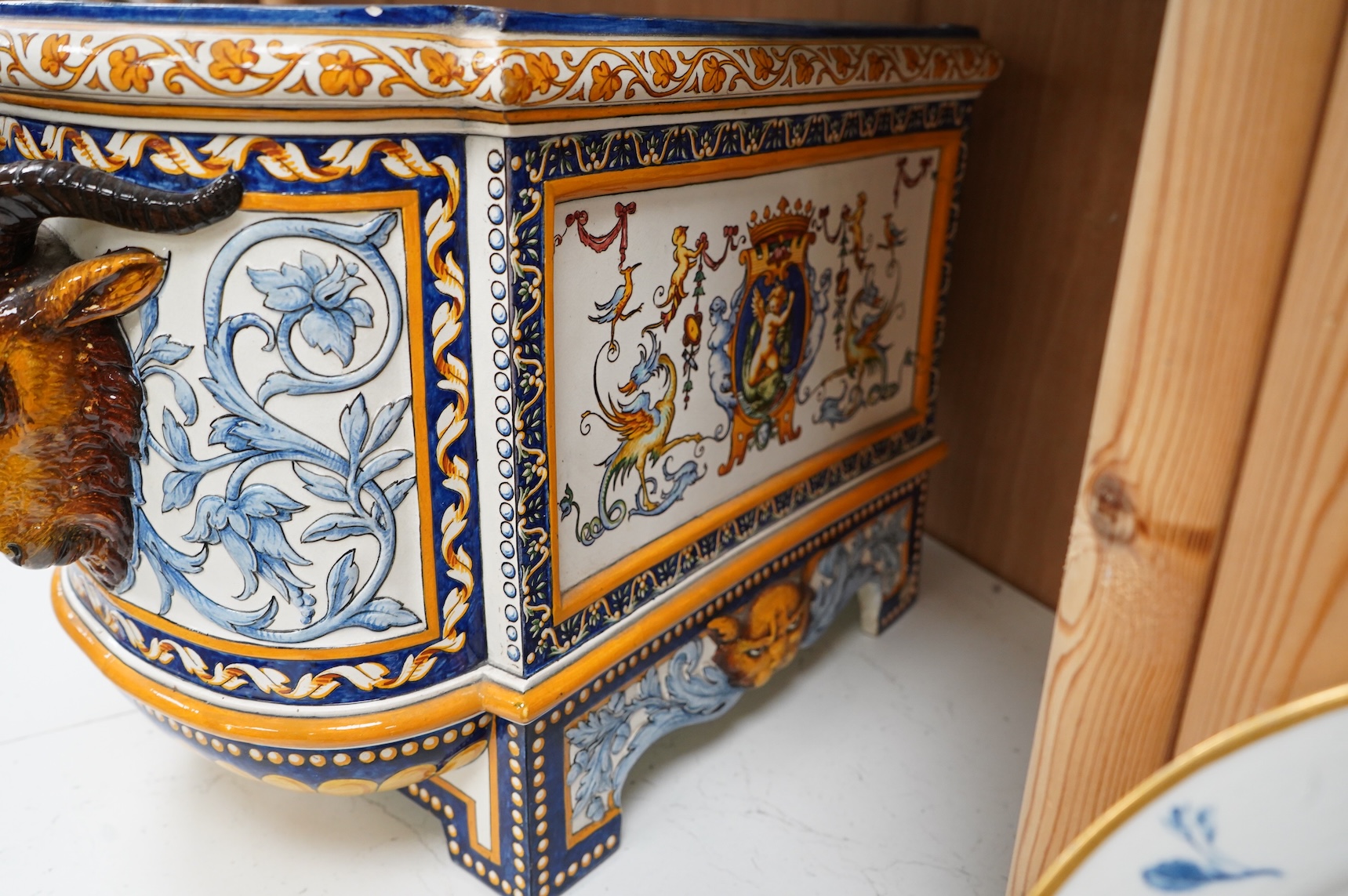 A large 19th century French faience wine cooler or planter with ram’s head handles, 60cm wide